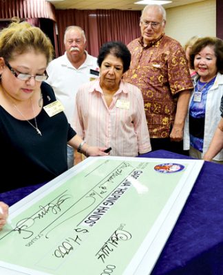 Helping Hands 2014 get annual Elks Lodge launch Alyssa signs check.jpg